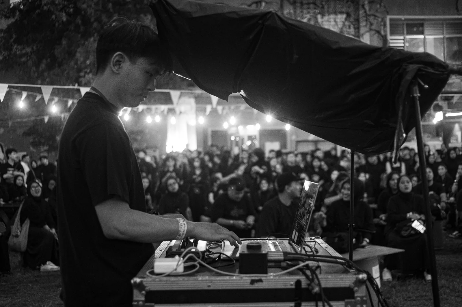 Stevie J. Sutanto performing with laptop in front of an audience